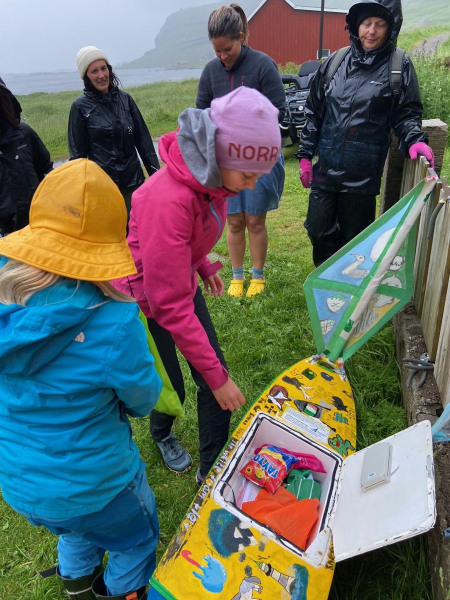 Bjørnsen family and friends discover the treasures inside the mini-boat 'Seoltóir Na Gaillimhe – the Galway Sailor’, after discovering it washed up on Bunes Beach above the Arctic Circle in the Lofoten Islands, in Norway. Photograph: Mr Lars Bjørnsen 
