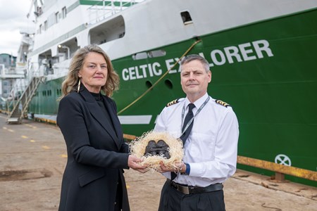 Caroilín Callery of the National Famine Way handing over the Bronze Shoes to Captain Denis Rowan, RV Celtic Explorer. Picture credit XPOSURE