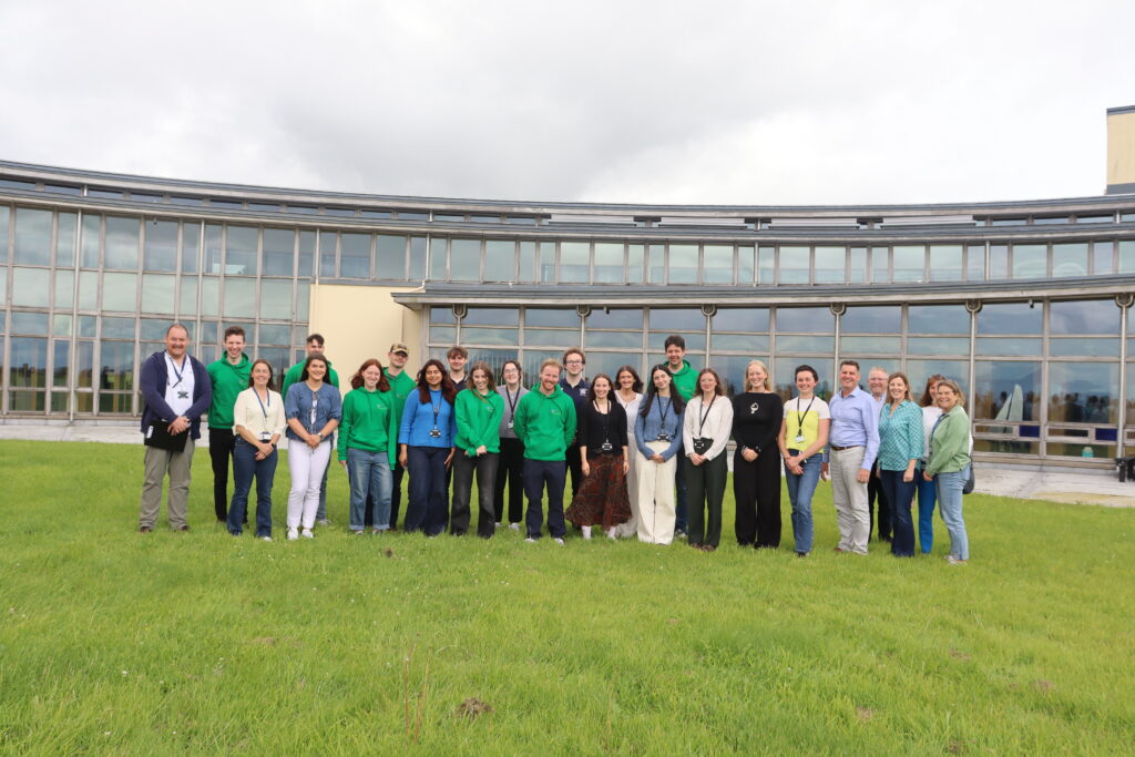 A group of Bursars from 2025 standing togeter with the organiser team near the Marine Institute HQ in Oranmore.