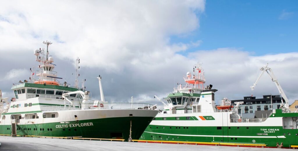 RV Celtic Explorer and RV Tom Crean moored side by side at a harbour quay.